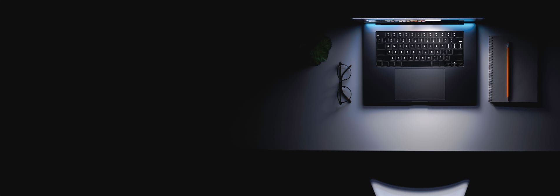 Laptop workspace on a dark desk