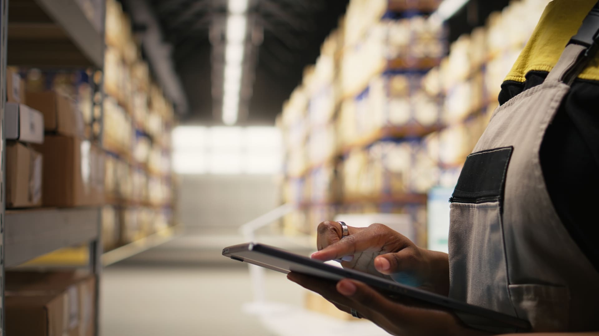 Warehouse team member checking inventory details on a tablet